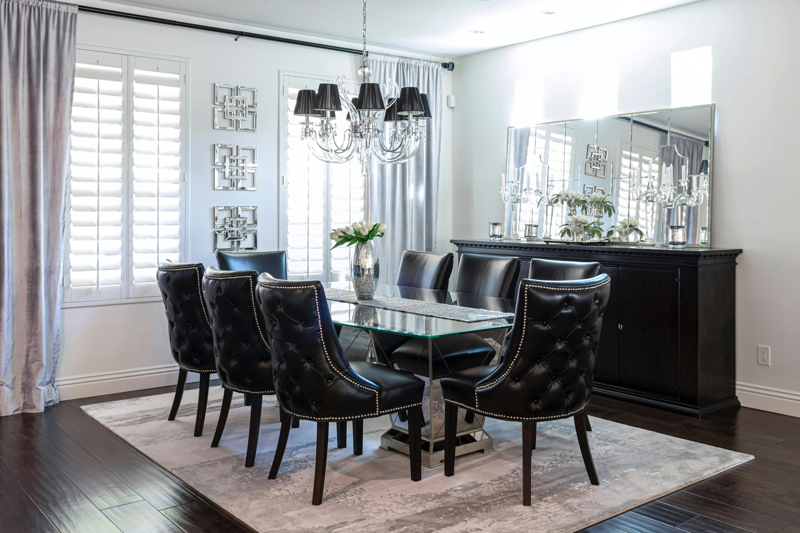 A sophisticated modern dining room featuring luxury decor and chic furnishings.
