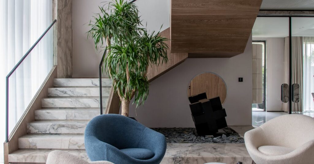 Elegant modern living room featuring unique chairs, art, and staircase for luxury appeal.