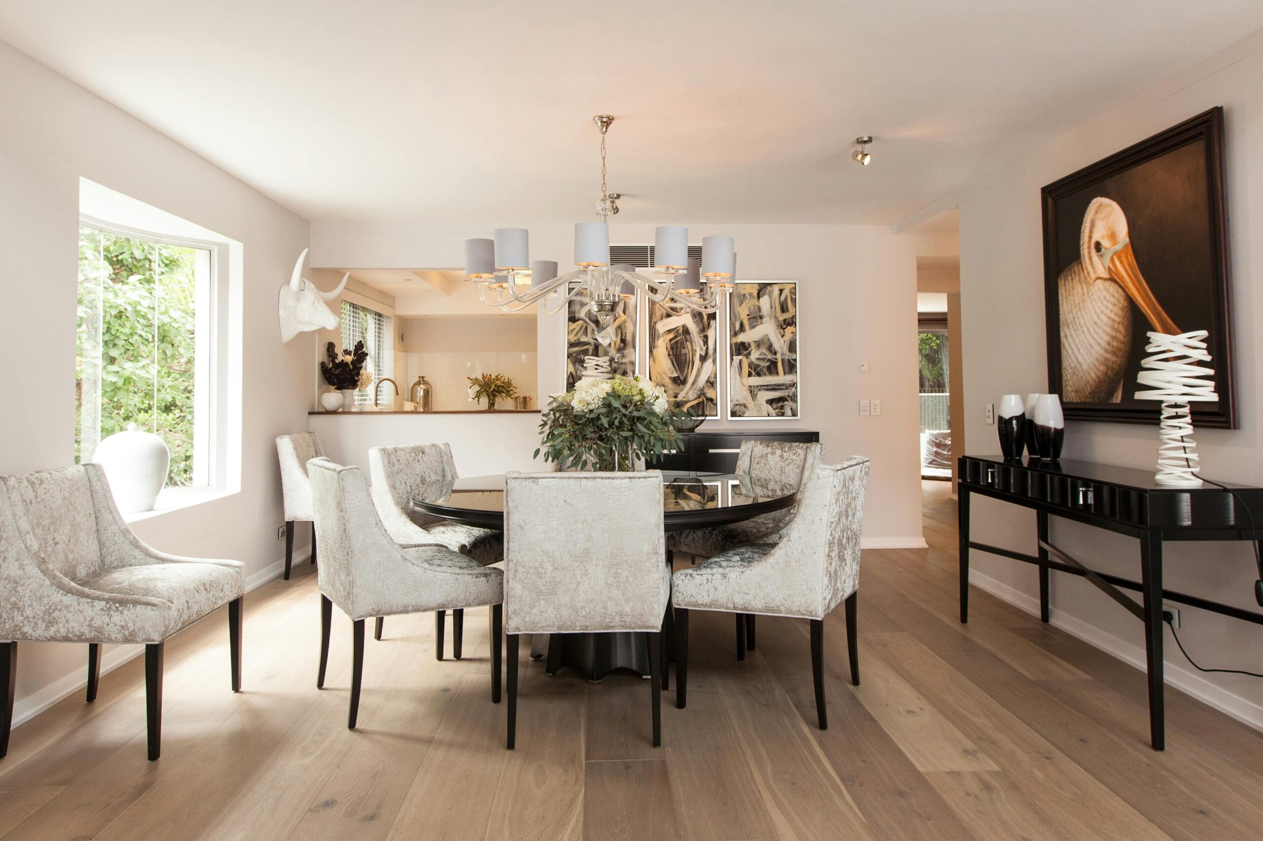 Bright modern dining room with elegant chairs and a stylish table, showcasing sophisticated interior design.