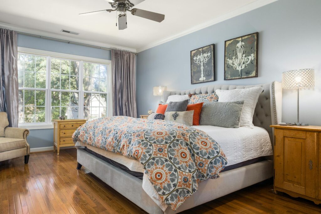 Elegant bedroom interior with wooden furniture and vibrant decor for a serene home atmosphere.